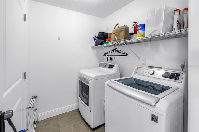 100 Windrush Blvd Unit 1, Indian Rocks Beach, FL 33785 - laundry room with washer and clothes dryer, light tile patterned floors, and baseboards