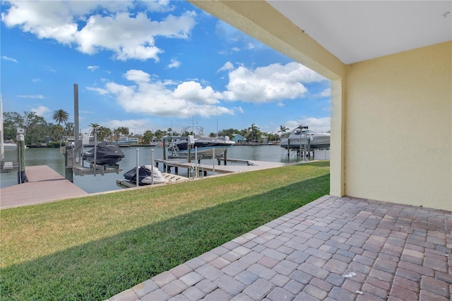 100 Windrush Blvd Unit 1, Indian Rocks Beach, FL 33785 - dock with boat lift, a water view, and a yard