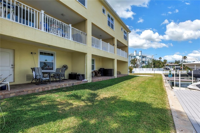 100 Windrush Blvd Unit 1, Indian Rocks Beach, FL 33785 - exterior space featuring stucco siding, a yard, and a patio area