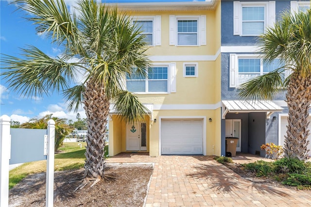 100 Windrush Blvd Unit 1, Indian Rocks Beach, FL 33785 - multi unit property featuring stucco siding, an attached garage, fence, and decorative driveway