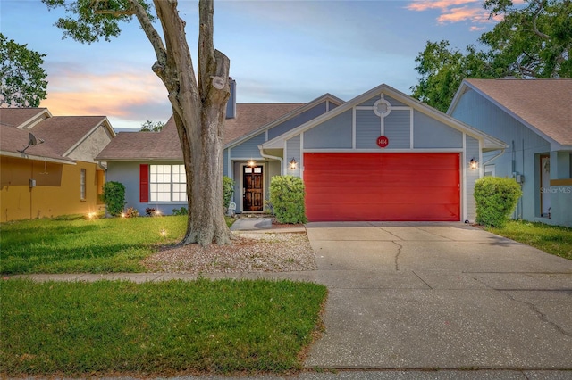 view of front of home featuring a garage, driveway, and a front yard