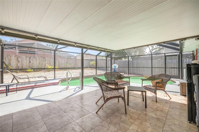 sunroom / solarium with a swimming pool