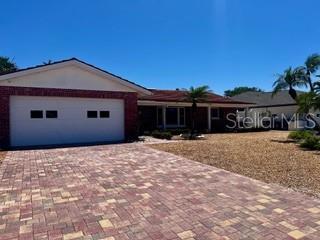 ranch-style home featuring decorative driveway and a garage