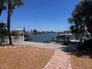 dock area with a water view and boat lift