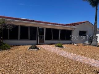 back of property featuring a sunroom