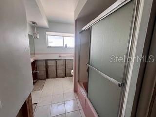 full bath featuring tile patterned floors