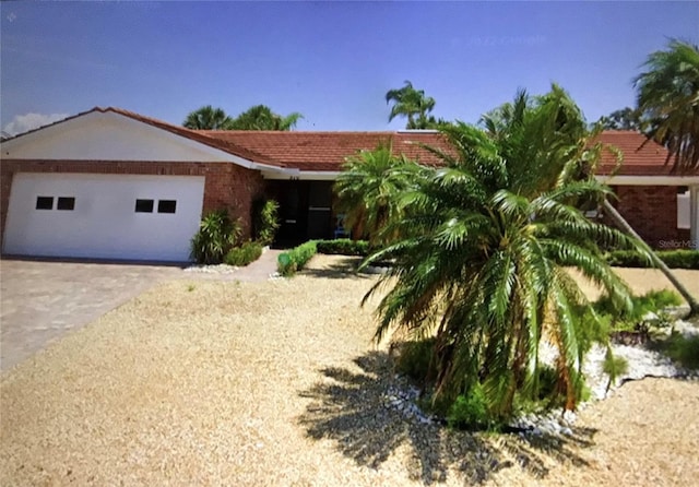 510 64th Ave, St Pete Beach, FL 33706 - ranch-style house featuring an attached garage and driveway
