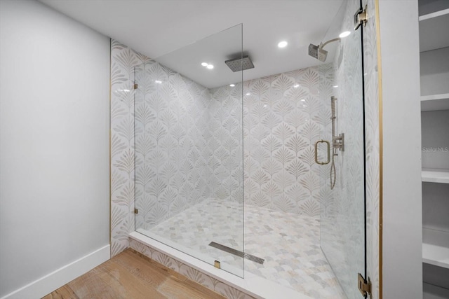 bathroom with recessed lighting, a shower stall, and wood finished floors