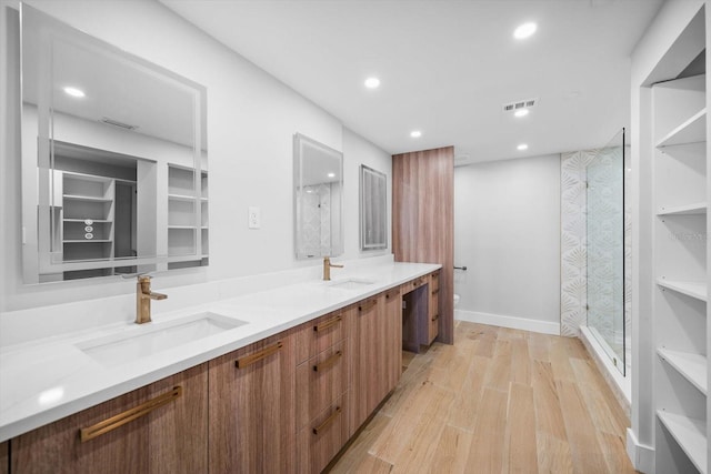 full bathroom with a sink, a stall shower, recessed lighting, and visible vents