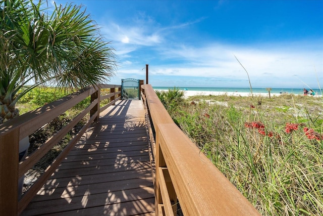 view of home's community featuring a water view and a view of the beach