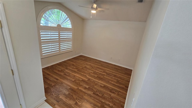 unfurnished room with ceiling fan, dark wood-style floors, baseboards, and lofted ceiling