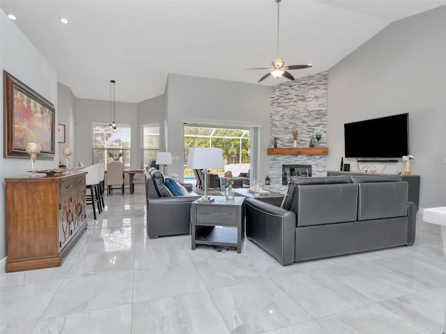 living room with high vaulted ceiling, a ceiling fan, a stone fireplace, and marble finish floor