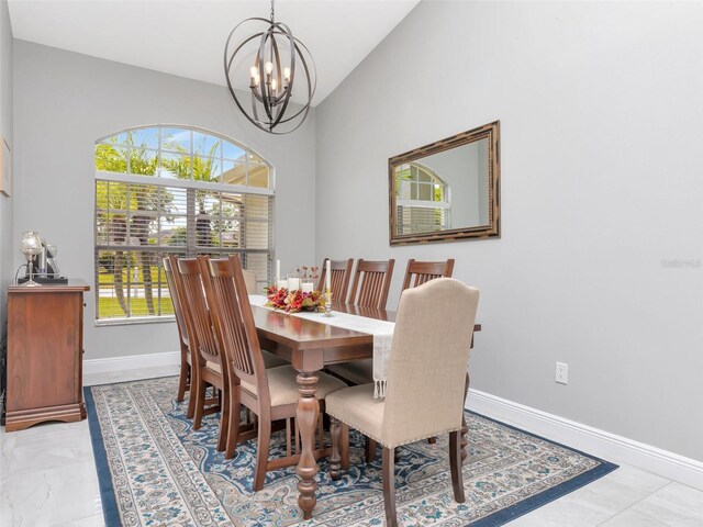 dining room featuring baseboards, high vaulted ceiling, a notable chandelier, and marble finish floor