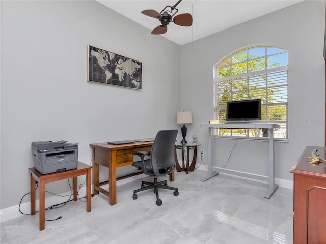 office featuring ceiling fan, marble finish floor, and baseboards