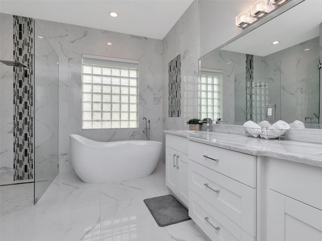 full bathroom with recessed lighting, vanity, a marble finish shower, marble finish floor, and a freestanding bath