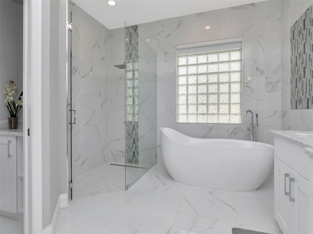 bathroom with a soaking tub, a marble finish shower, recessed lighting, vanity, and marble finish floor