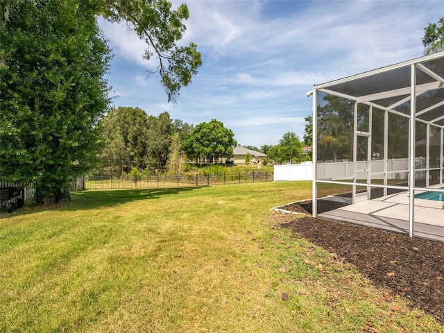 view of yard featuring a patio area, glass enclosure, and a fenced backyard