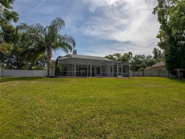 view of yard featuring a lanai and a fenced backyard