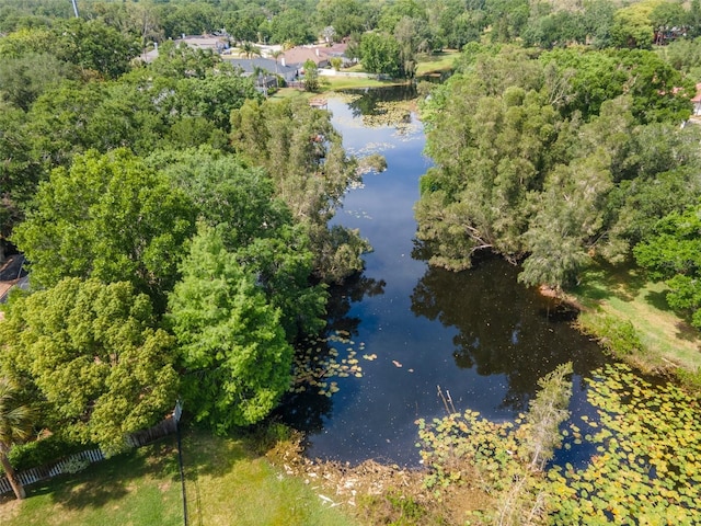 aerial view with a water view and a forest view