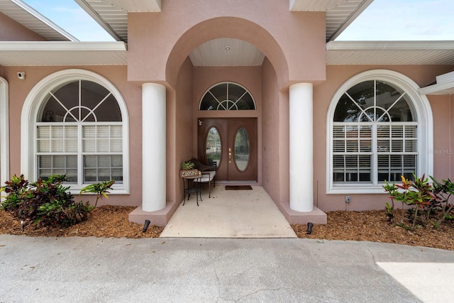 4022 Valrico Grove Dr, Valrico, FL 33594 - doorway to property with stucco siding, french doors, and a surveillance system