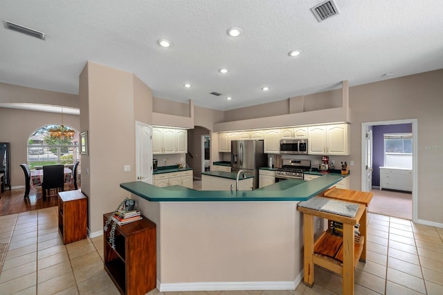 4022 Valrico Grove Dr, Valrico, FL 33594 - kitchen featuring appliances with stainless steel finishes, light tile patterned flooring, plenty of natural light, a textured ceiling, and recessed lighting