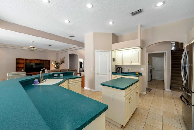 4022 Valrico Grove Dr, Valrico, FL 33594 - kitchen with arched walkways, a sink, freestanding refrigerator, a center island, and a ceiling fan