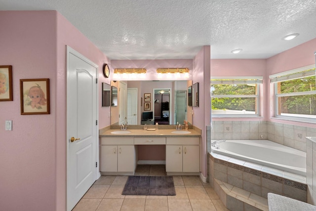 4022 Valrico Grove Dr, Valrico, FL 33594 - bathroom with double vanity, tile patterned floors, a textured ceiling, and a garden tub