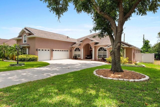 4022 Valrico Grove Dr, Valrico, FL 33594 - view of front facade featuring an attached garage, stucco siding, and driveway
