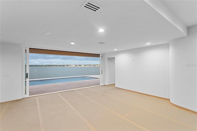spare room featuring recessed lighting, visible vents, floor to ceiling windows, and baseboards