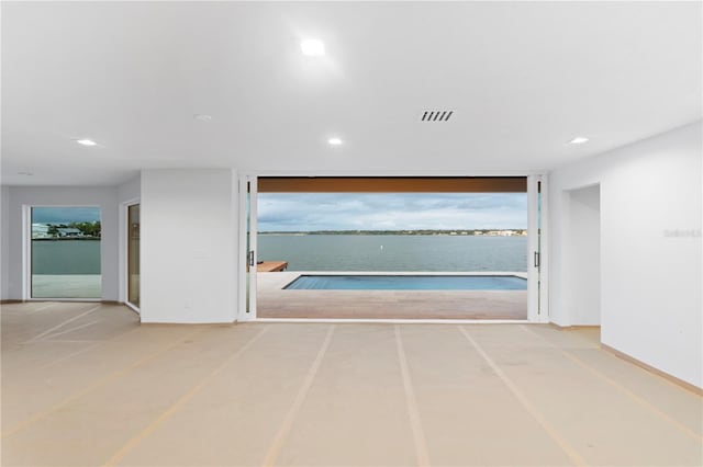corridor with recessed lighting, visible vents, and baseboards