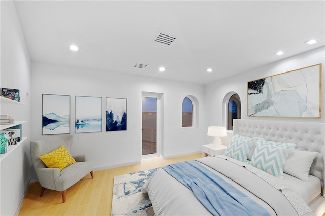 bedroom featuring wood finished floors, visible vents, and recessed lighting