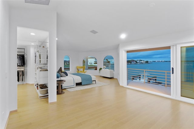 bedroom featuring wood finished floors, visible vents, recessed lighting, and access to exterior