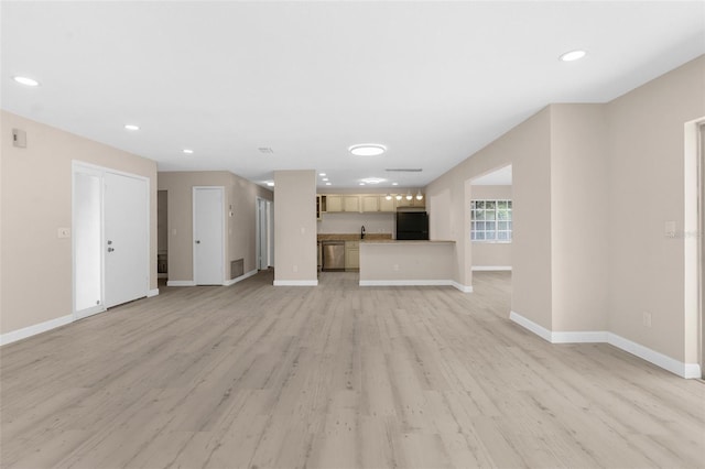 unfurnished living room featuring recessed lighting, light wood finished floors, a sink, baseboards, and visible vents