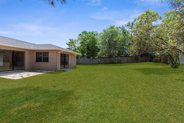 view of yard with a patio area and a fenced backyard