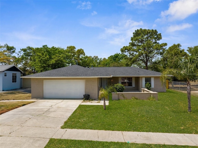 single story home with a front yard, a garage, concrete driveway, stucco siding, and fence