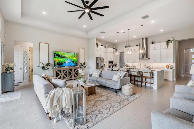 living area with light tile patterned flooring, ceiling fan, recessed lighting, and visible vents