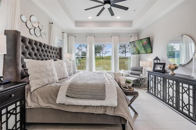 tiled bedroom with a raised ceiling, ornamental molding, and multiple windows