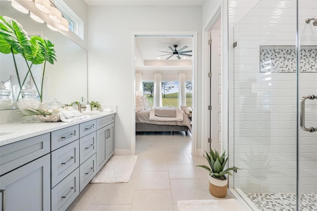 bathroom with a shower stall, ceiling fan, tile patterned floors, ensuite bath, and double vanity
