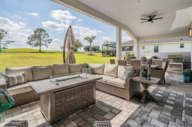 view of patio featuring an outdoor living space with a fire pit, area for grilling, a ceiling fan, and grilling area