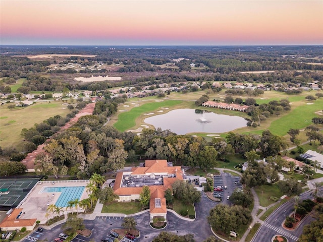 birds eye view of property with a water view and golf course view