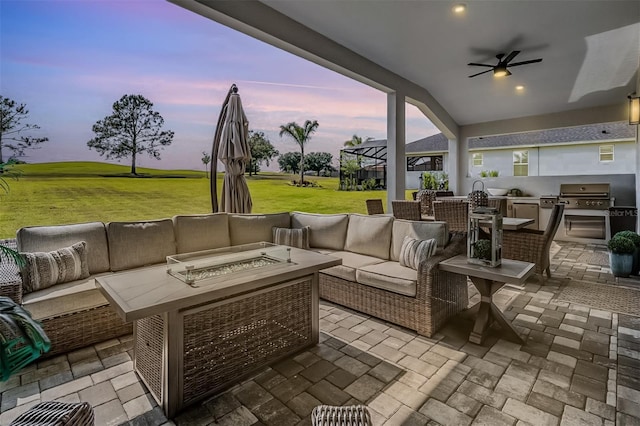 view of patio featuring an outdoor living space with a fire pit, area for grilling, ceiling fan, and a grill