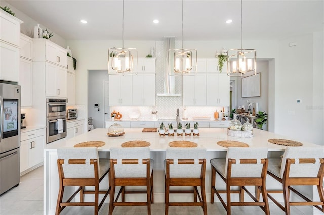 kitchen with appliances with stainless steel finishes, tasteful backsplash, light countertops, and a sink