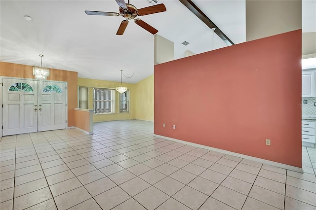 unfurnished living room with light tile patterned floors, visible vents, high vaulted ceiling, and ceiling fan with notable chandelier