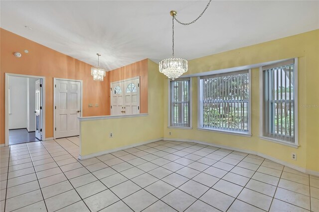 unfurnished dining area with light tile patterned floors, a notable chandelier, and plenty of natural light