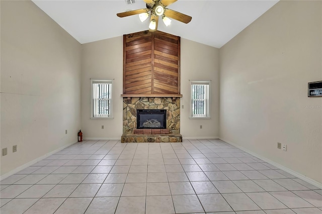 unfurnished living room featuring light tile patterned flooring, ceiling fan, a stone fireplace, and high vaulted ceiling