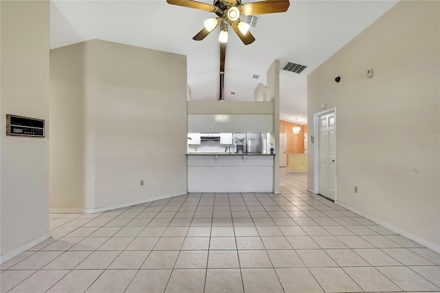 unfurnished living room featuring light tile patterned flooring, high vaulted ceiling, a ceiling fan, visible vents, and baseboards