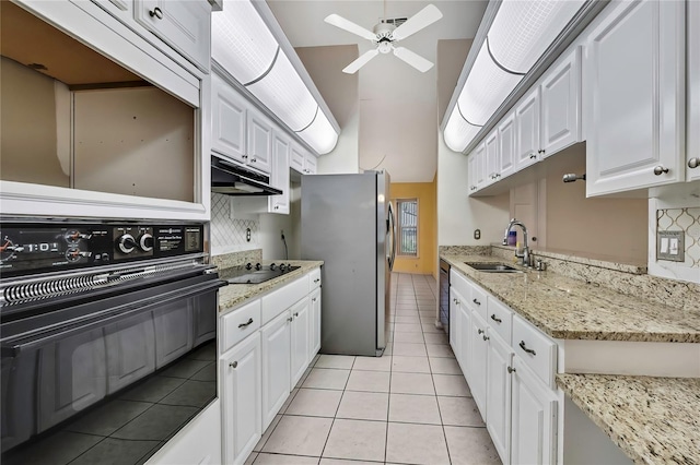 kitchen featuring under cabinet range hood, black appliances, backsplash, a sink, and a ceiling fan
