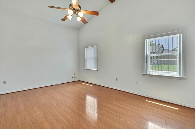 unfurnished room featuring baseboards, wood finished floors, ceiling fan, and beamed ceiling