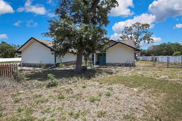 back of house with fence