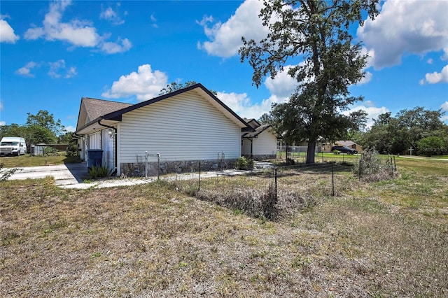 view of home's exterior with fence